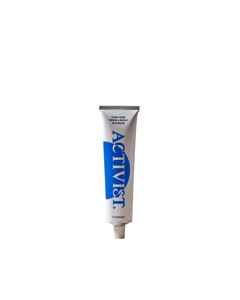 Front view of Activist Manuka Honey Mask tube showcasing its blue Activist label on a black background