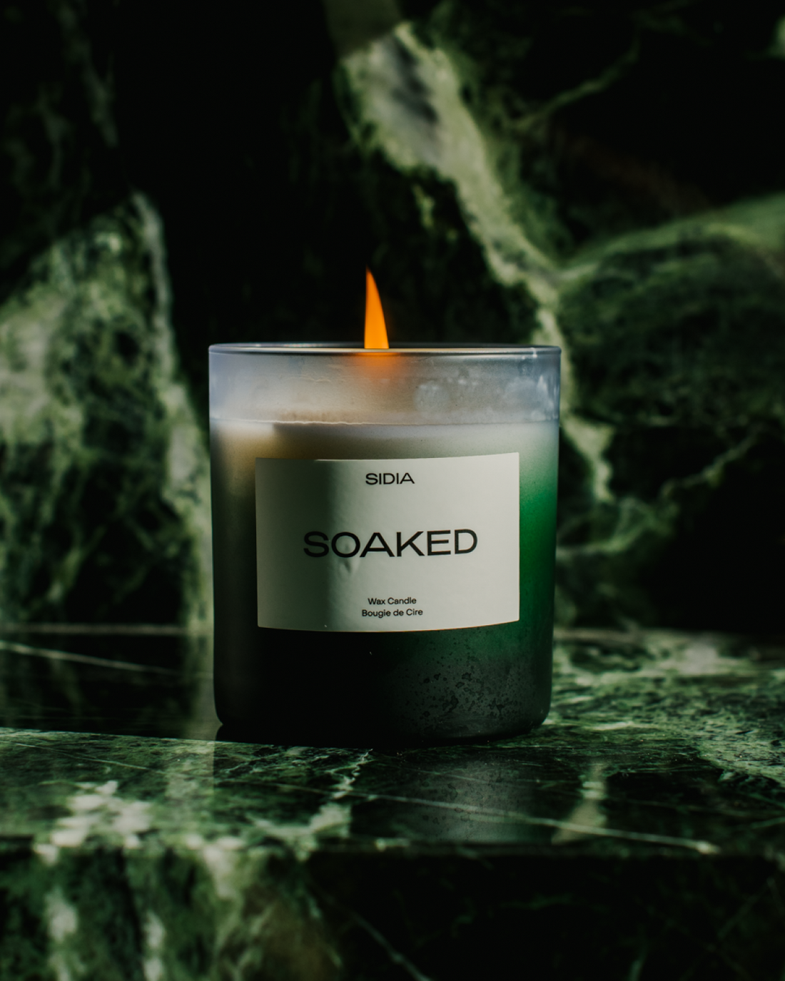 Lit SIDIA Soaked Candle on green countertop - Formula Fig