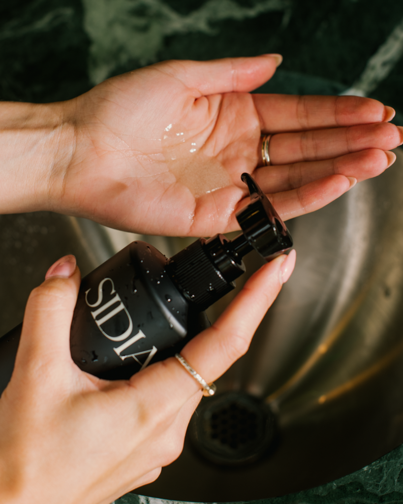 The Hand Exfoliant being used over a sink.