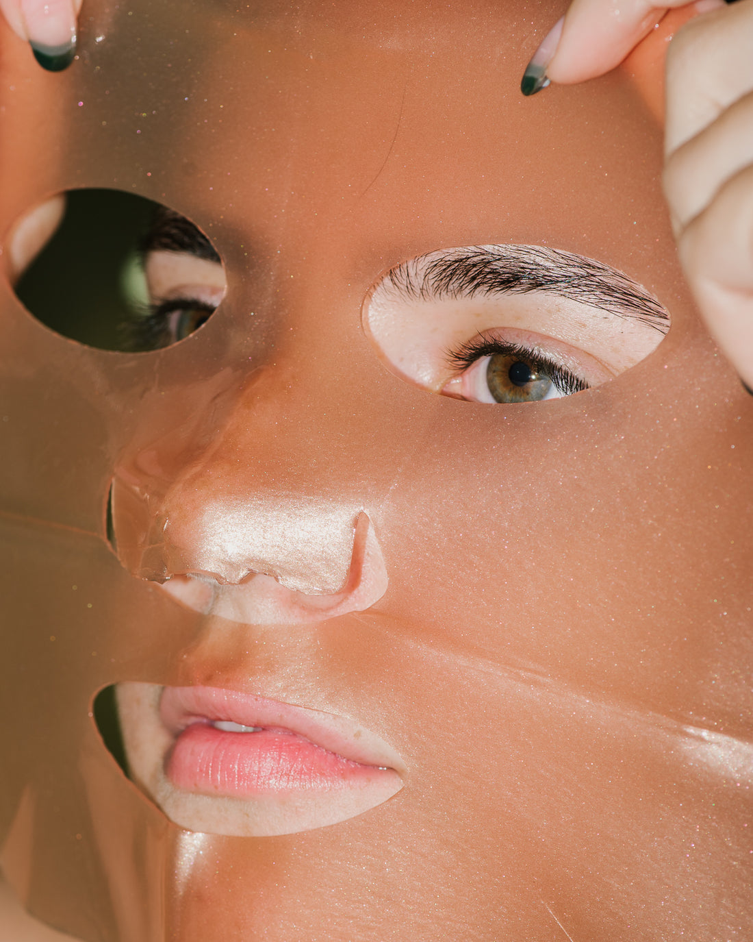 Close up of Rose Gold Brightening Facial Treatment Mask on skin. 