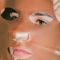 Close up of Rose Gold Brightening Facial Treatment Mask on skin. 