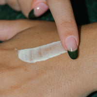 Close up of Concentrated Firming Moisturizer on skin.
