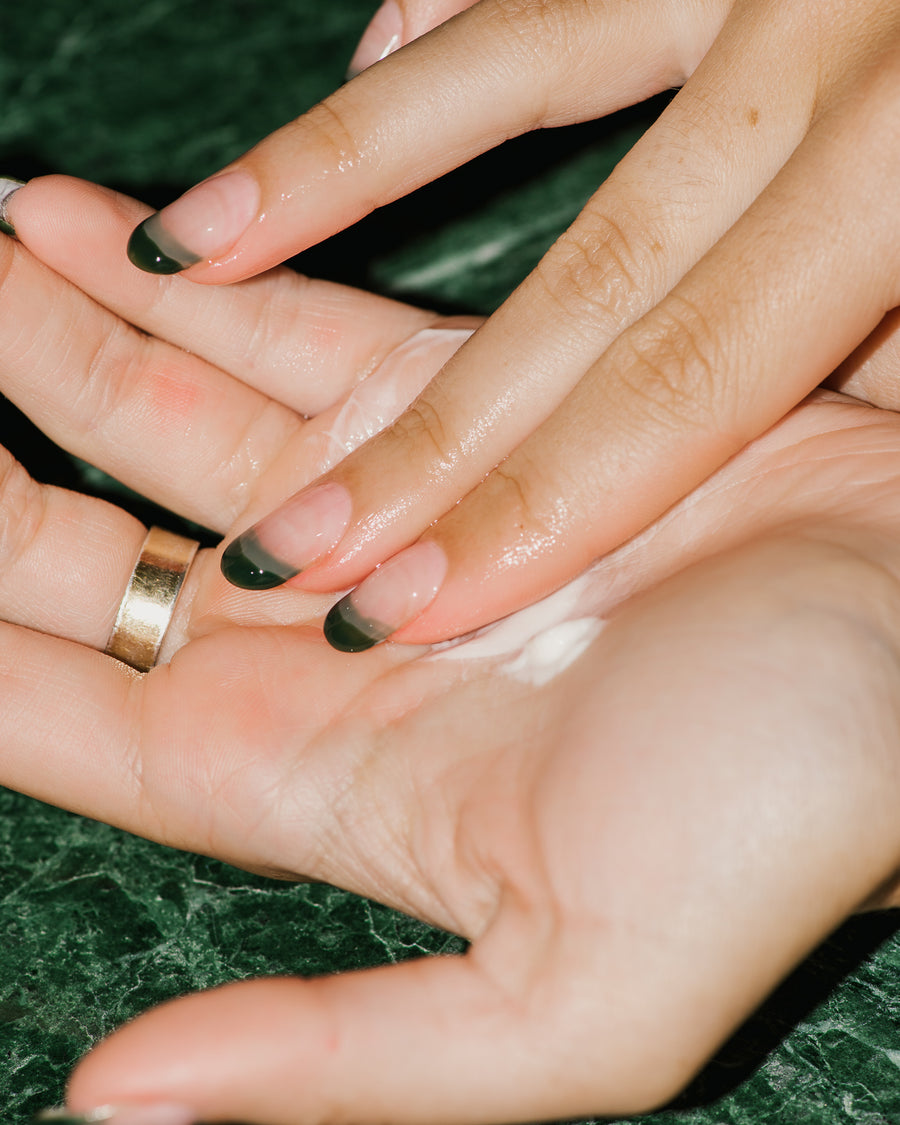 Close up of Natural Cleansing Lotion in palms of hands.