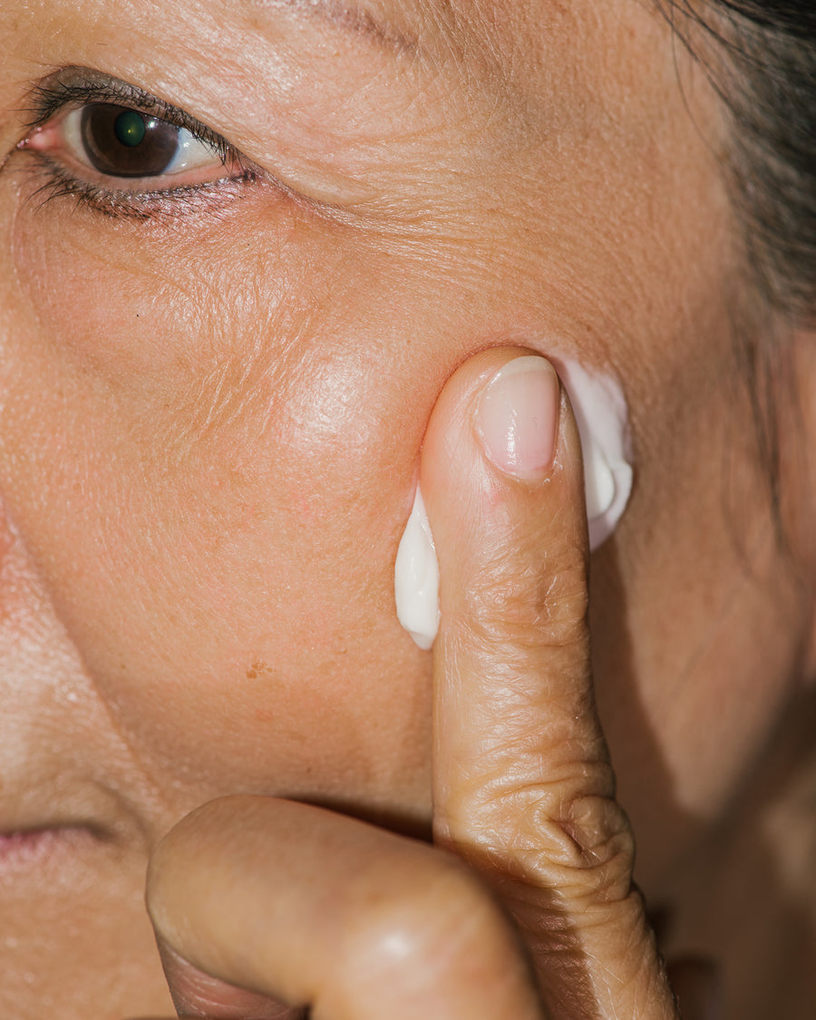 Close up of GOOPGENES Nourishing Face Cream on face.