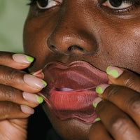 Close up of Collagen-Infused Lip Mask pack on skin.