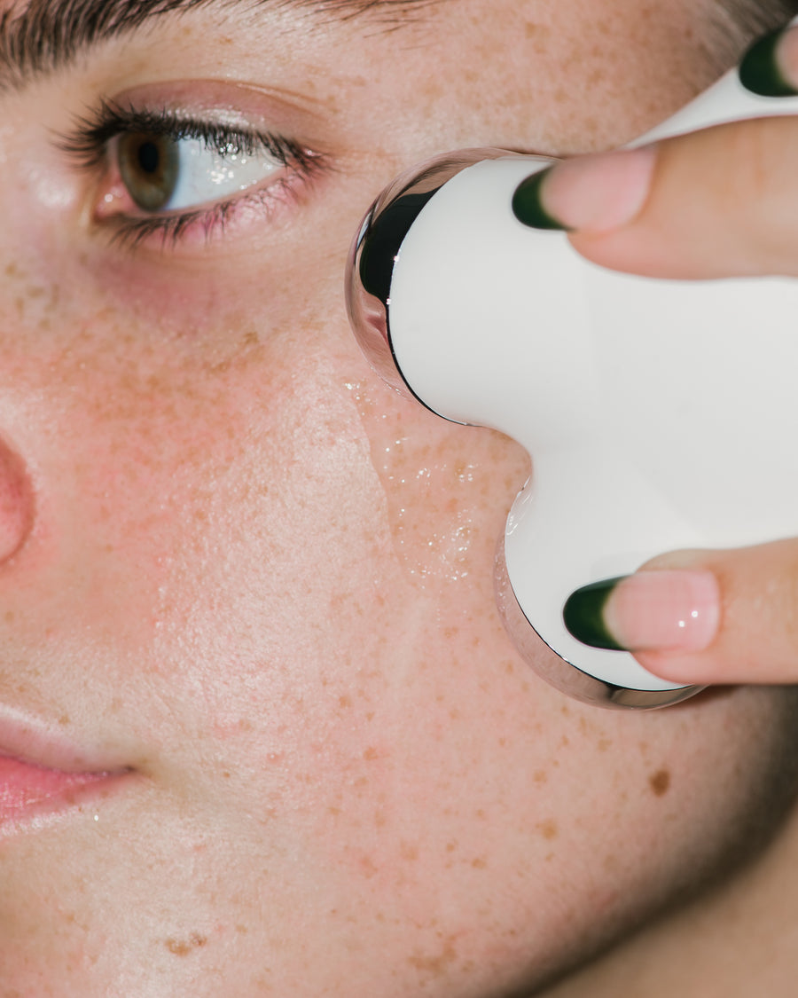 Close up of MINI Facial Toning Device on skin.