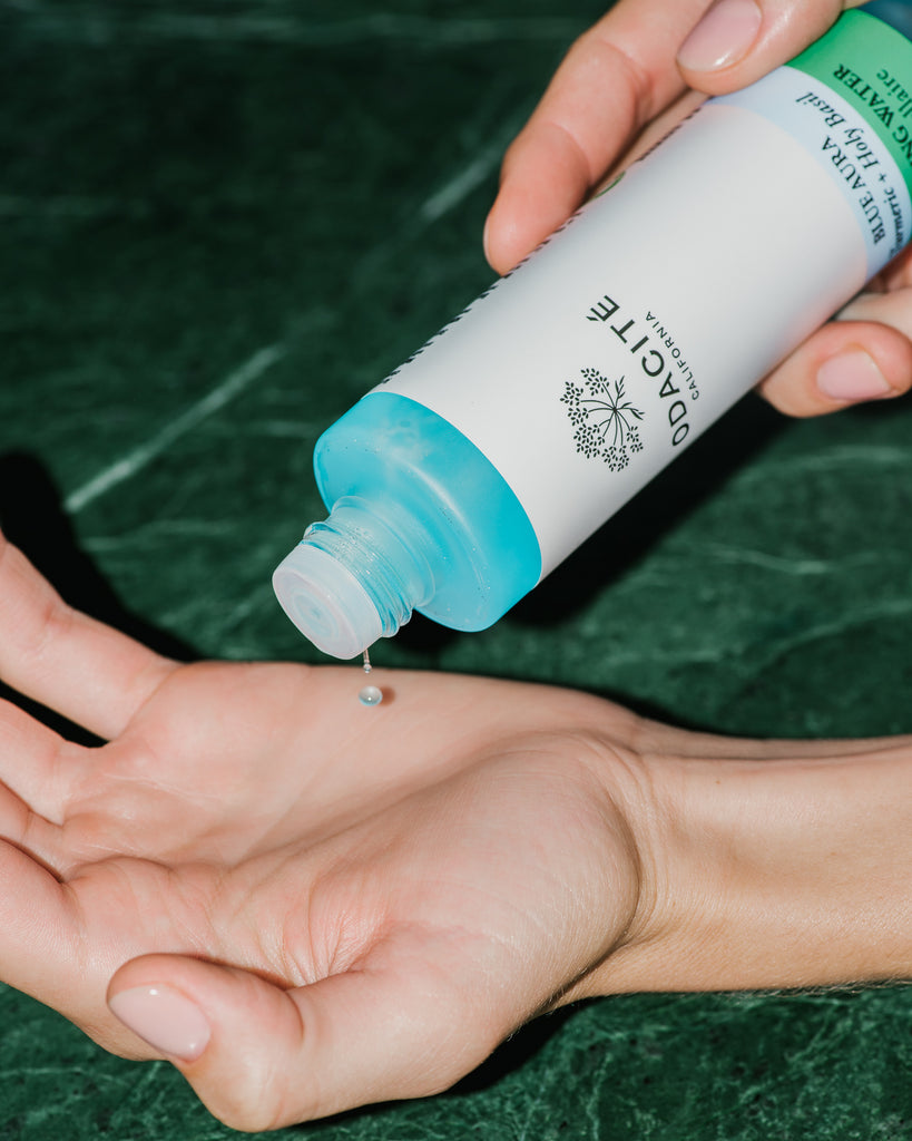 Close up of Blue Aura Cleansing Water on skin.