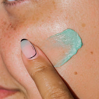 Close up of Diamant Bleu Clarifying Cream on skin.